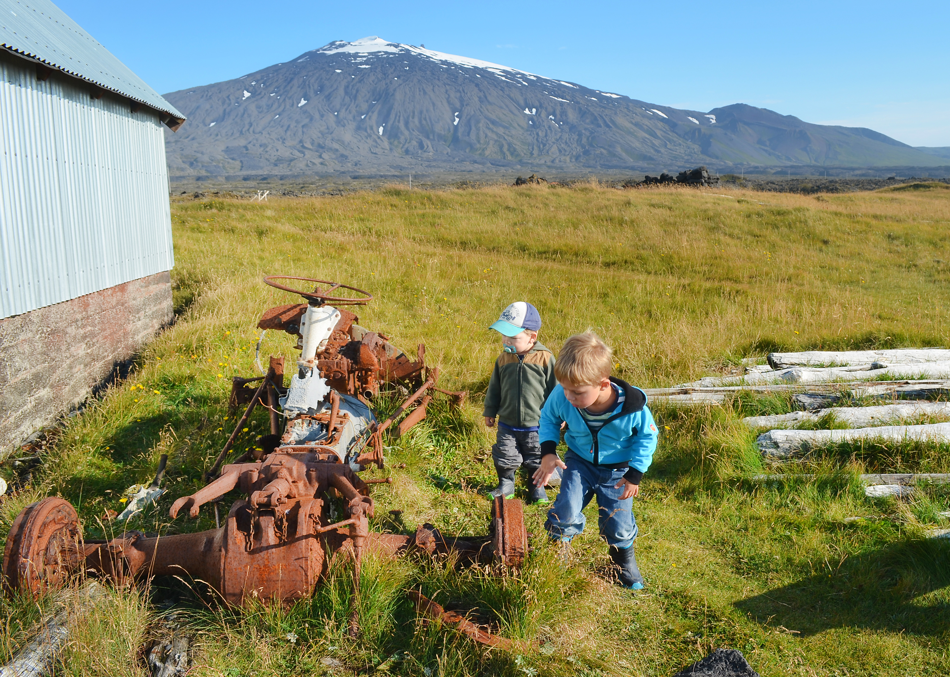 Kinder spielen und entdecken einen alten verrosteten Traktor