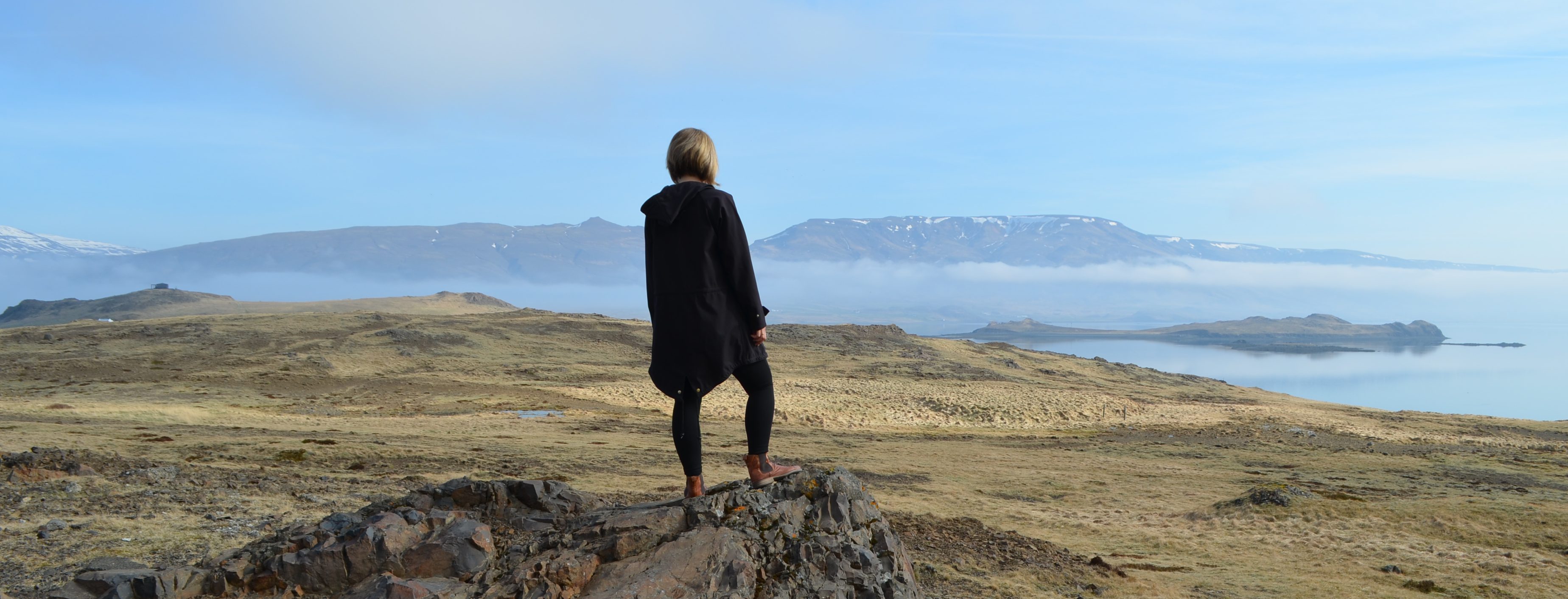 Walfjord in Westisland - Reisende schaut in die Ferne